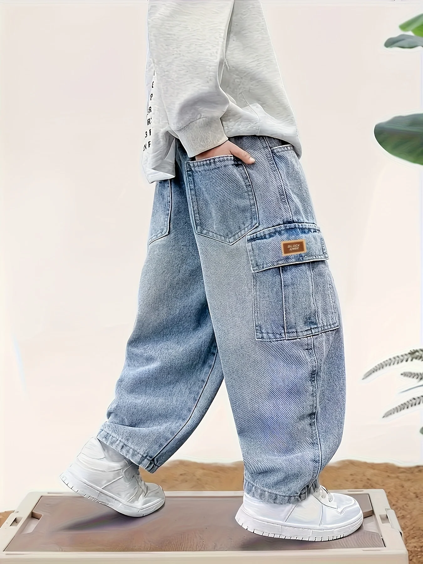 Boy's loose-fit stylish denim work pants with label design, comfortable elasticized waist, and trendy versatile style. - Image 2